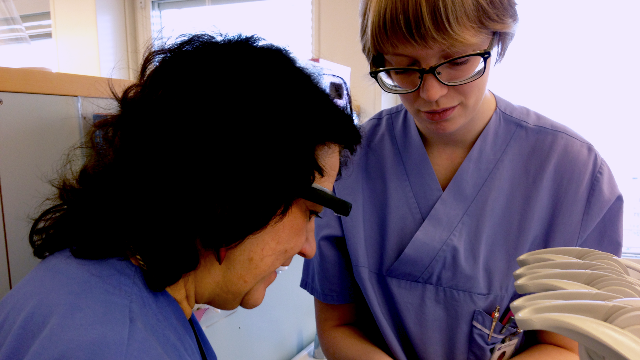 A teacher and student work with google glass.