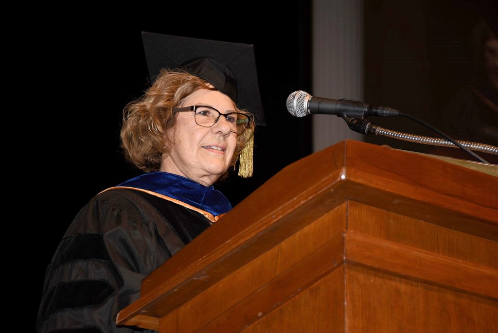 Kathy Banks in regalia at a podium