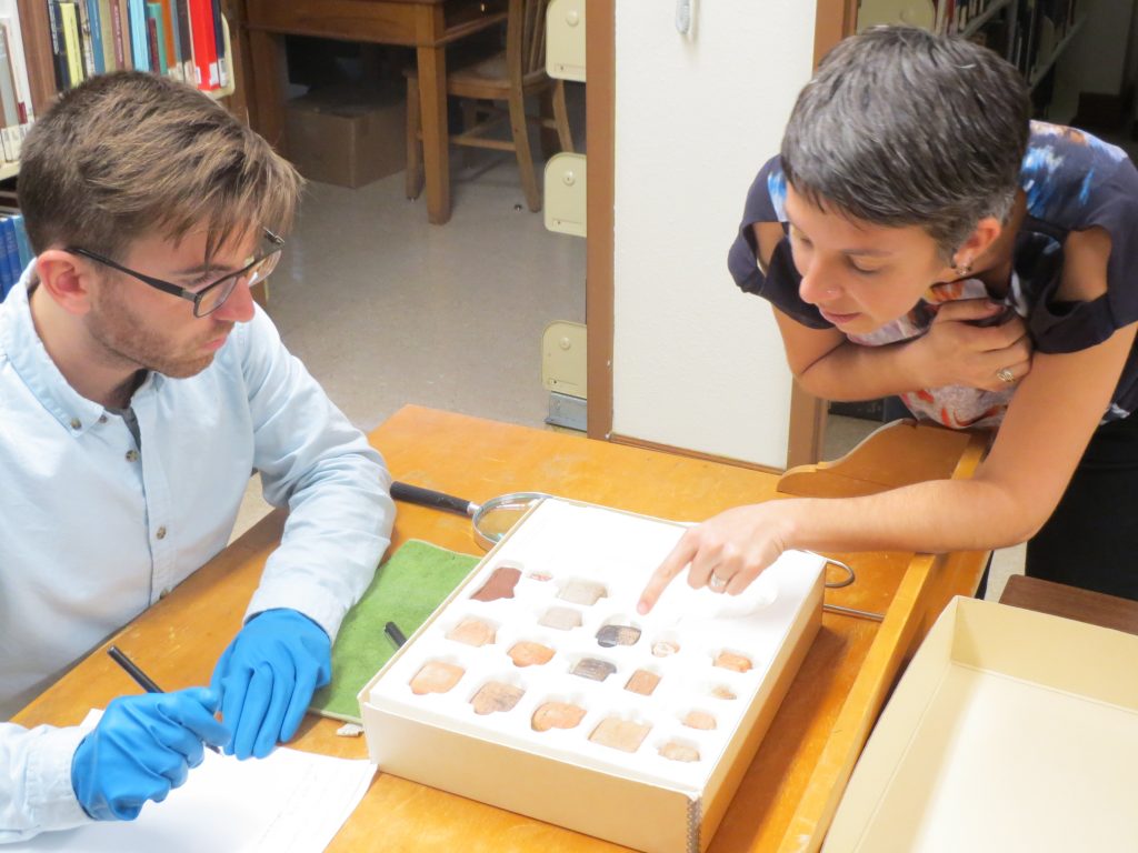 Two people examining photos