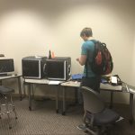 Pictures of the Lab. From left to right: Dremel 3D printer, Computer, 2 Afinia H800 3D Printers and student visitor.